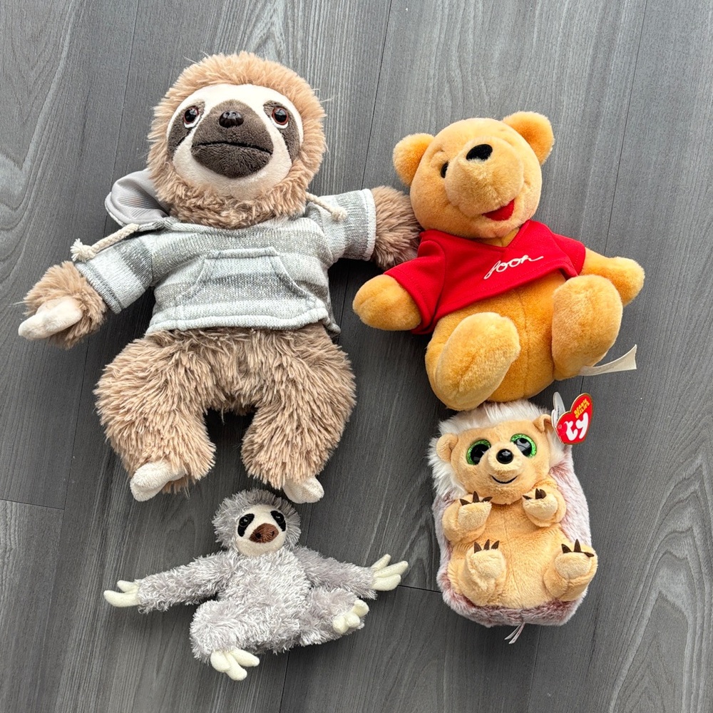 Sloth, Pooh bear, and TY stuffed animals